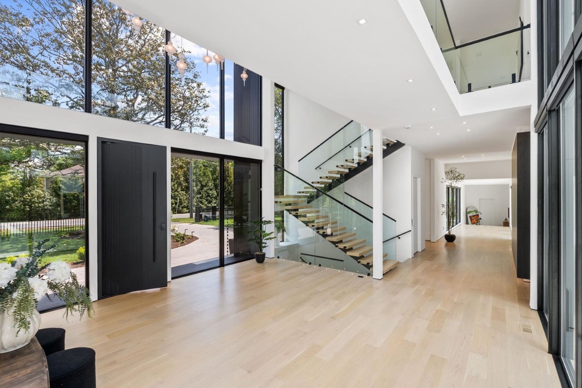 Two storey entry with floating staircase, glass rail and white oak floors